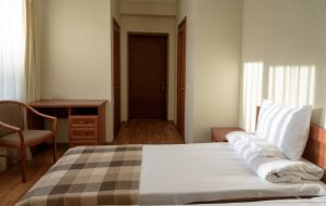interior of comfortable budget hotel bedroom with bed interior of comfortable budget hotel bedroom with bed